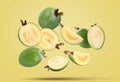 Fresh feijoa fruits falling on pale yellow background