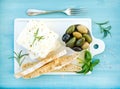 Fresh feta cheese with olives, basil, rosemary and bread slices Royalty Free Stock Photo