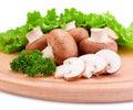 Fresh field mushroom and Leaves of green on a cutting board wooden Royalty Free Stock Photo