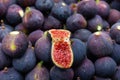 Fresh fig open in half on top of full purple ones Royalty Free Stock Photo