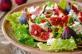 Fresh fig salad with pomegranate seeds, feta cheese, and greens Royalty Free Stock Photo