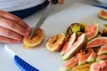 Fresh figs being cut on a cutting board