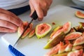 Fresh figs being cut on a cutting board