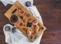 Fresh figs, chocjlate and pekan nuts with honey on a wooden boar