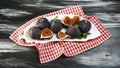 Fresh figs with mint leaves on a plate, black wooden table. copy text. Flat lay Royalty Free Stock Photo