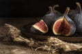 Fresh figs in moody natural lighting set with vintage retro style