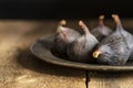 Fresh figs in moody natural lighting set with vintage retro style