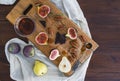 Fresh figs, pears and pekan nuts with honey on a wooden board