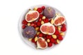 Fresh figs, strawberries and raspberries on white ceramic plate isolated on white background. top view Royalty Free Stock Photo