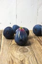 Fresh figs on wooden surface with light background, space for copy