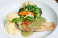 Fresh fillet of sea bass pan fried in lemon caper sauce served with mashed potatoes and green vegetables Royalty Free Stock Photo