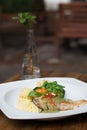 Fresh fillet of sea bass pan fried in lemon caper sauce served with mashed potatoes and green vegetables Royalty Free Stock Photo