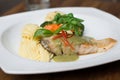 Fresh fillet of sea bass pan fried in lemon caper sauce served with mashed potatoes and green vegetables Royalty Free Stock Photo