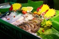 Fresh fish, cuttlefish, squid and shrimp for sale at a fish cafe in Thailand at night. Seafood on ice on the counter