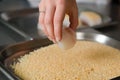 Fresh fish fillet cube being placed into breadcrumbs,before being pan fried. organic line and pole fish caught for restaurants
