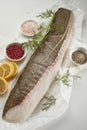 Fresh fish fillet on white table with assorted spices Royalty Free Stock Photo