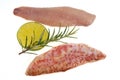 Raw red mullet fillets with a lemon slice and rosemary close-up on a white background