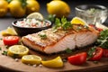 fresh fish fillets displayed on a cutting board, surrounded by lemons, tomatoes, and vegetables Royalty Free Stock Photo
