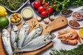 Fresh Fish Food background. Different seafood, shrimps and red caviar. Fish for cooking with herbs, vegetables and spices isolated Royalty Free Stock Photo