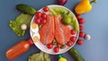 Fresh Fish Raw Salmon Two steaks with ingredients vegetables and spices tomatoes lemon and olives cucumber green salat onion g Royalty Free Stock Photo