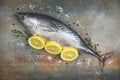 Fresh fish with herbs spices rosemary and lemon - Raw fish seafood on black plate background top view , Longtail tuna , Eastern