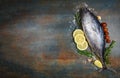 Fresh fish with herbs spices rosemary tomato and lemon - Raw fish seafood on black plate background , Longtail tuna , Eastern