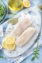 Fresh fish, raw cod fillets with addition of herbs and lemon. Royalty Free Stock Photo