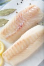 Fresh fish, raw cod fillets with addition of herbs and lemon. Royalty Free Stock Photo