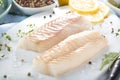 Fresh fish, raw cod fillets with addition of herbs and lemon. Royalty Free Stock Photo