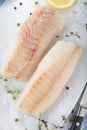 Fresh fish, raw cod fillets with addition of herbs and lemon. Royalty Free Stock Photo