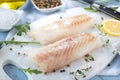 Fresh fish, raw cod fillets with addition of herbs and lemon. Royalty Free Stock Photo
