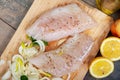 Fresh fish, raw cod fillets with addition of herbs and lemon Royalty Free Stock Photo