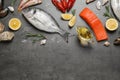 Fresh fish and seafood on grey table, flat lay. Space for text Royalty Free Stock Photo