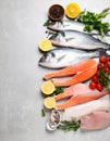 Fresh fish and seafood on grey table, flat lay. Royalty Free Stock Photo
