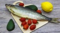 Fresh fish and vegetables on a cutting board Royalty Free Stock Photo