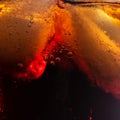 Fresh fizzy coke with bubbles and ice cubes background. Bubbly soda pop drink closeup