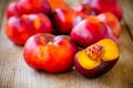 Fresh flat nectarines on a wooden background Royalty Free Stock Photo