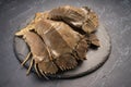 Fresh Flathead lobster on black plate, Raw Flathead lobster or Mantis shrimp on black plate on black background.