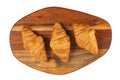 Fresh flavorous croissant on wooden table isolated on white Royalty Free Stock Photo