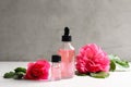 Fresh flowers and bottles of rose essential oil Royalty Free Stock Photo