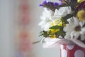 Fresh flowers in a box on a light background. Vintage style. Selective focus