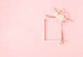 Fresh flowers composition and frame on pastel pink background. Minimal spring or summer concept. Wedding day or romantic