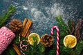 Fir tree branches dried orange slices cinnamon sticks pine cones twine on snowy dark blue turquoise backdrop. Christmas New Year