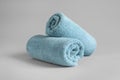 Fresh fluffy rolled towels on grey