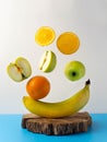 Fresh flying fruit on a blue-white background. Oranges, apples, banana.