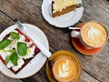 Fresh focaccia with tomato, basil and goat cottage cheese, two cups of coffee and carrot cake on wooden table. Italian Royalty Free Stock Photo