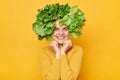 Fresh food care. Healthy eating habits. Organic salad greens. Cute charming woman with lettuce hair style with green vegetables on Royalty Free Stock Photo