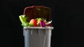 Fresh food in perfect condition in the garbage can to illustrate the waste that is thrown away daily without the need. waste of or Royalty Free Stock Photo