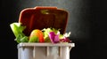 Fresh food in perfect condition in the garbage can to illustrate the waste that is thrown away daily without the need. waste of or Royalty Free Stock Photo