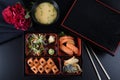 Fresh Food Portion in Japanese Bento Box with Sushi Rolls, Salad and Main Course.Rice and Fried Meat Royalty Free Stock Photo